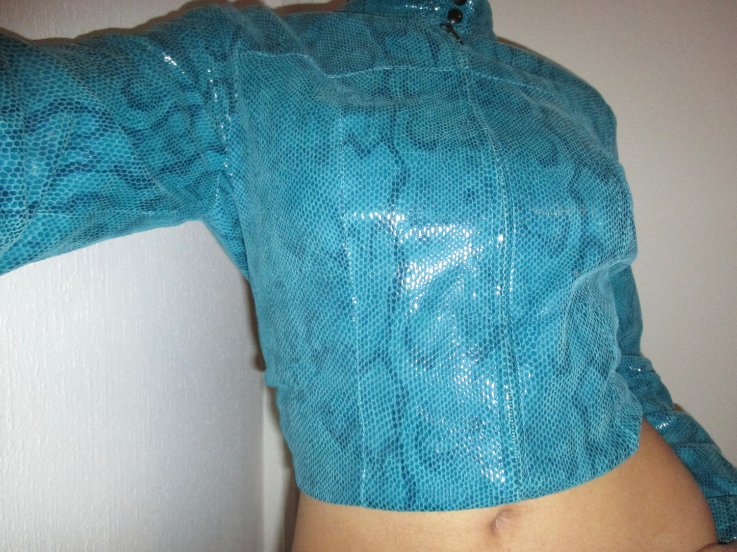 TURQUOISE JACKET WITH A GLOSSY SNAKE EFFECT